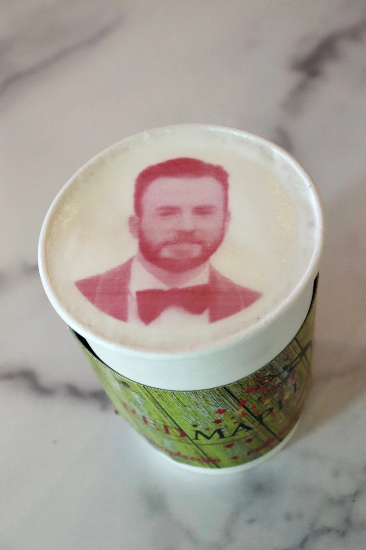 Printed portrait on the foam of a to-go latte