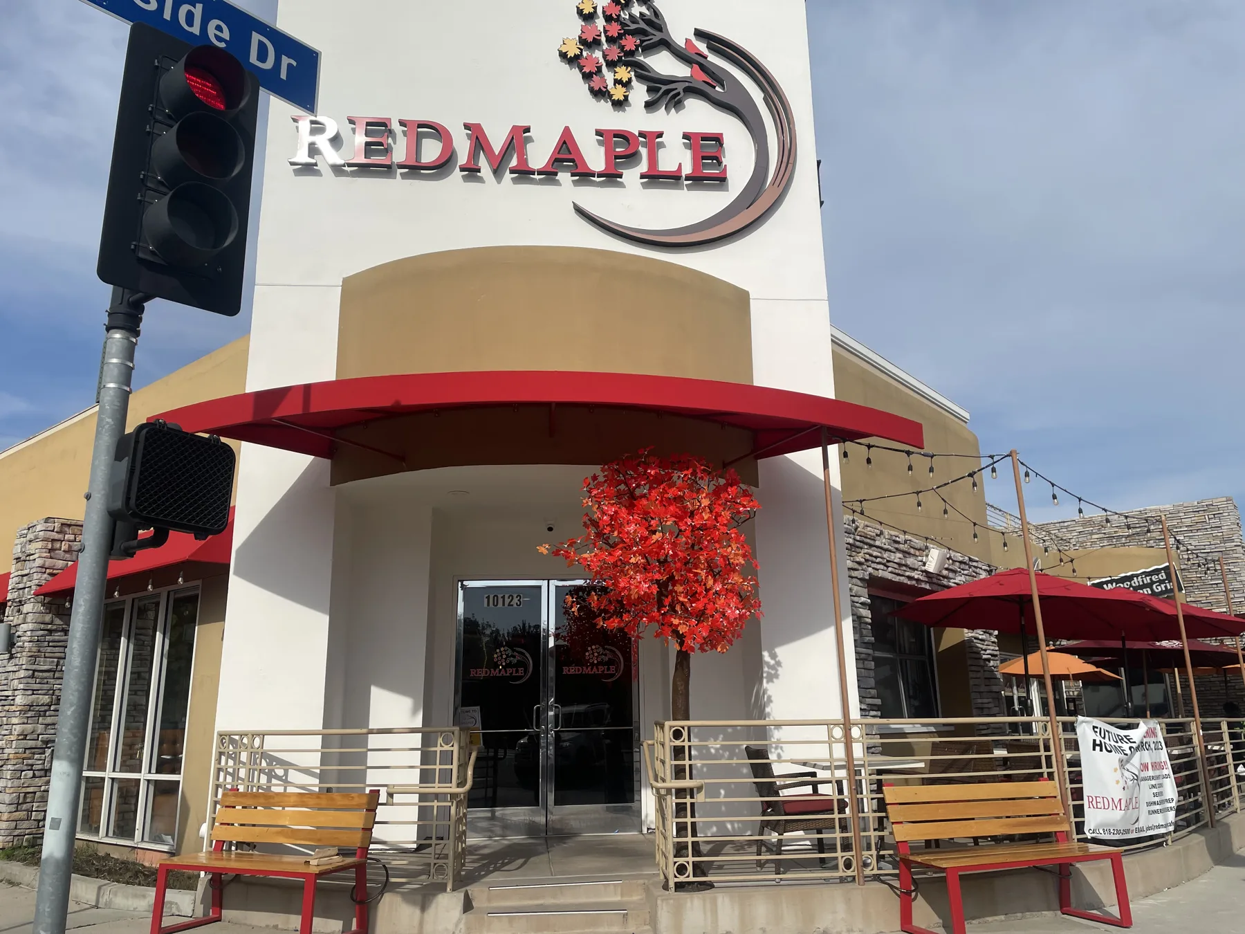 Red Maple Cafe exterior with its red awning and maple tree on Riverside Drive