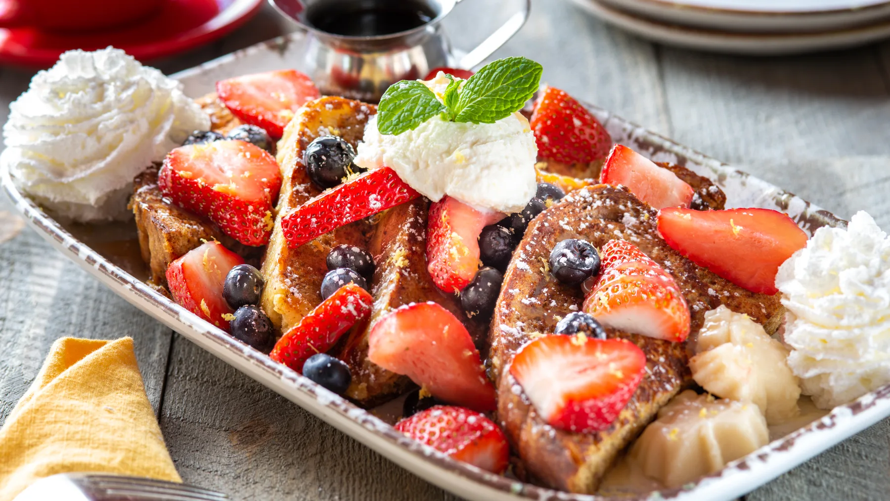 French toast piled with fresh strawberries and blueberries