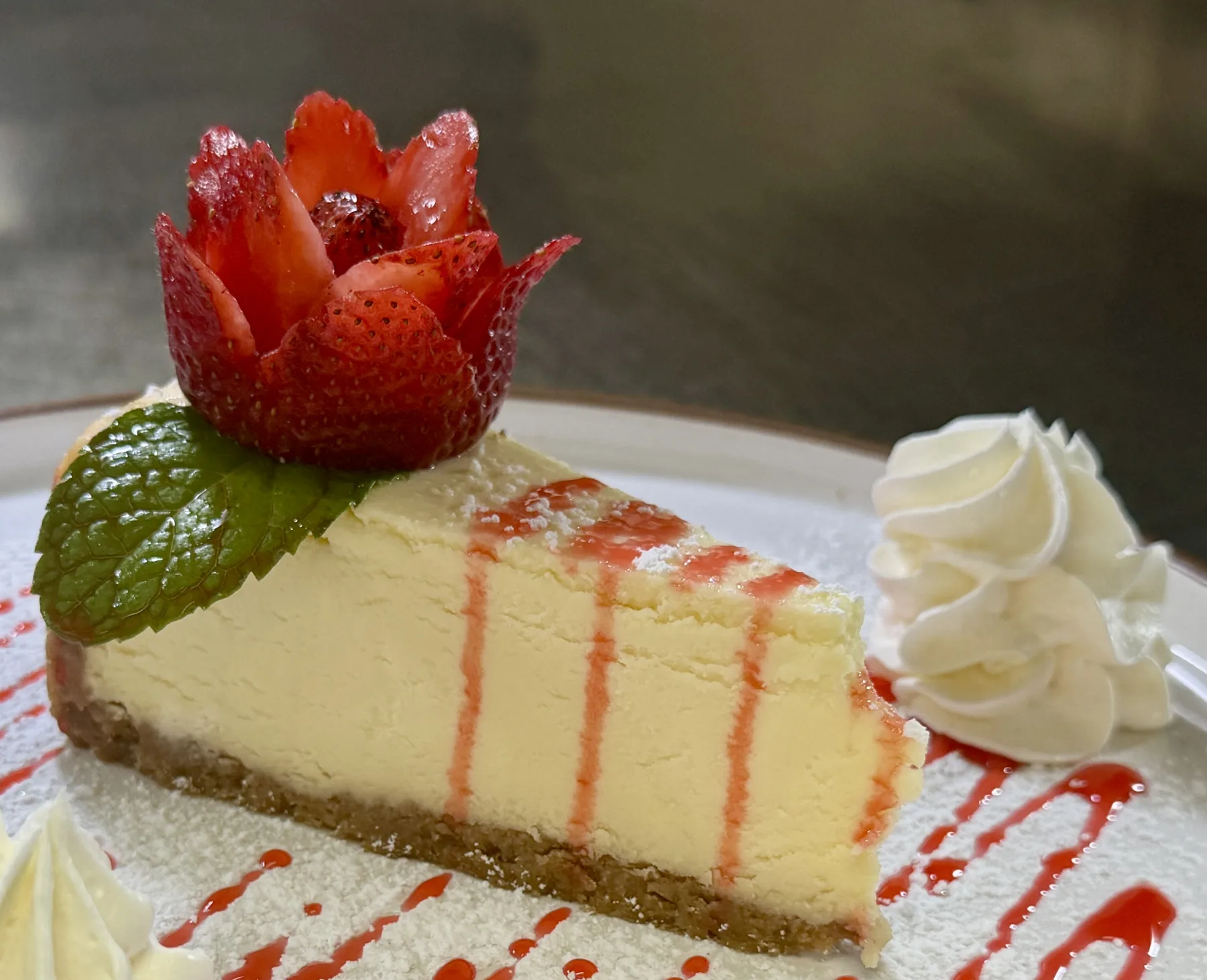 Slice of New York cheesecake with strawberry coulis