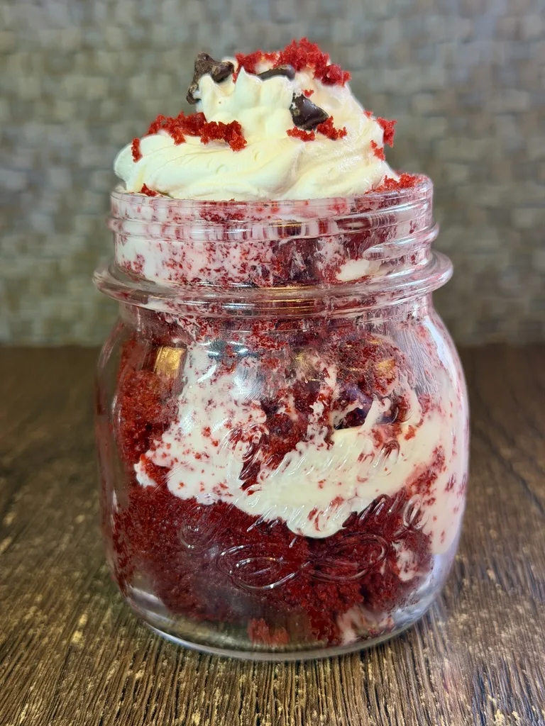 Red velvet dessert jar with vanilla cream and a strawberry