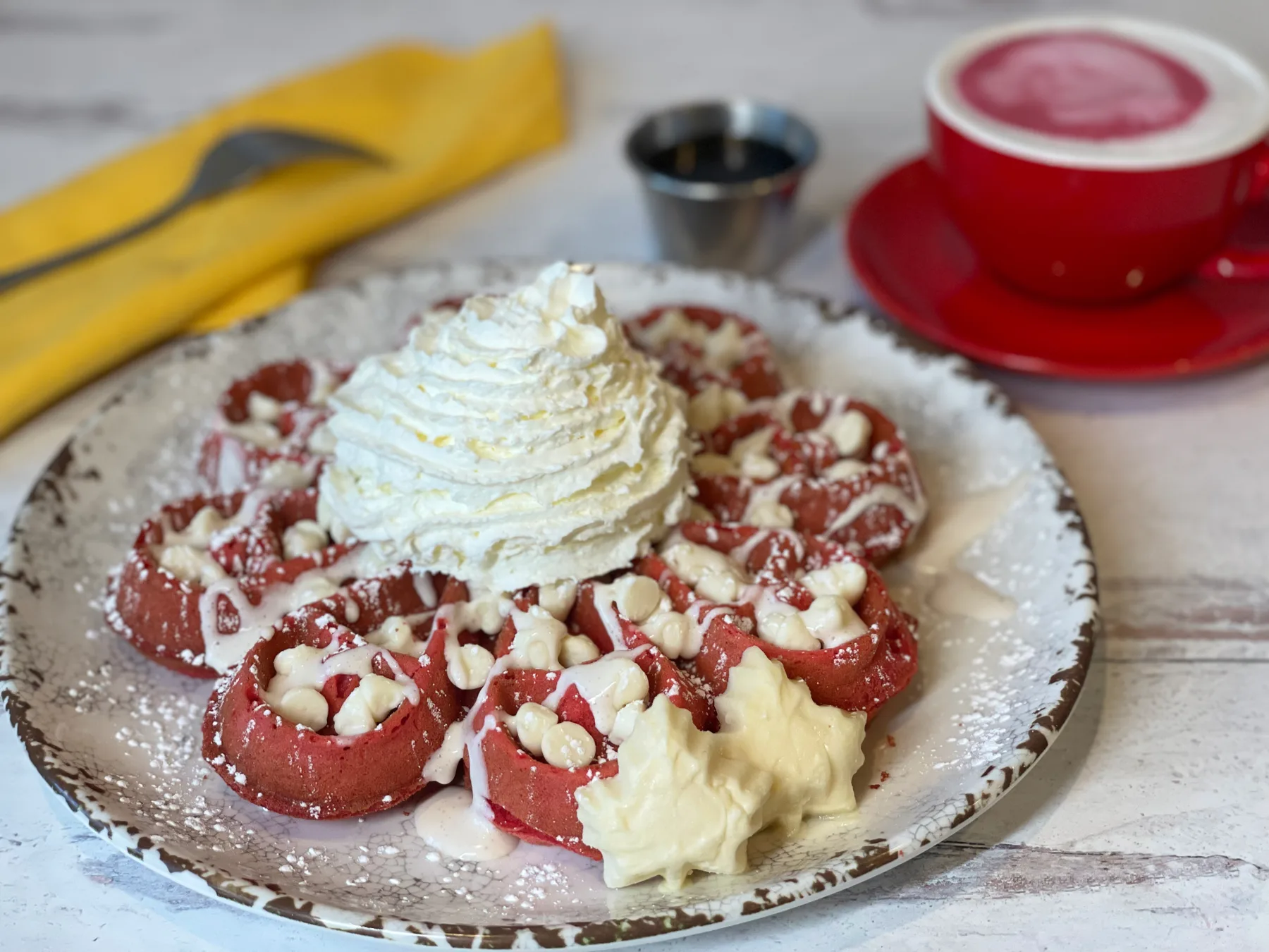 Red velvet Belgian waffle with vanilla cream cheese drizzle
