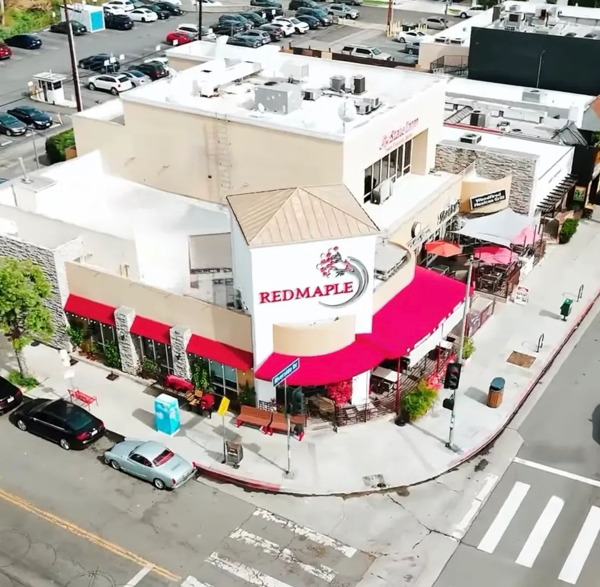 Red Maple Cafe exterior with its red awning and maple tree on Riverside Drive