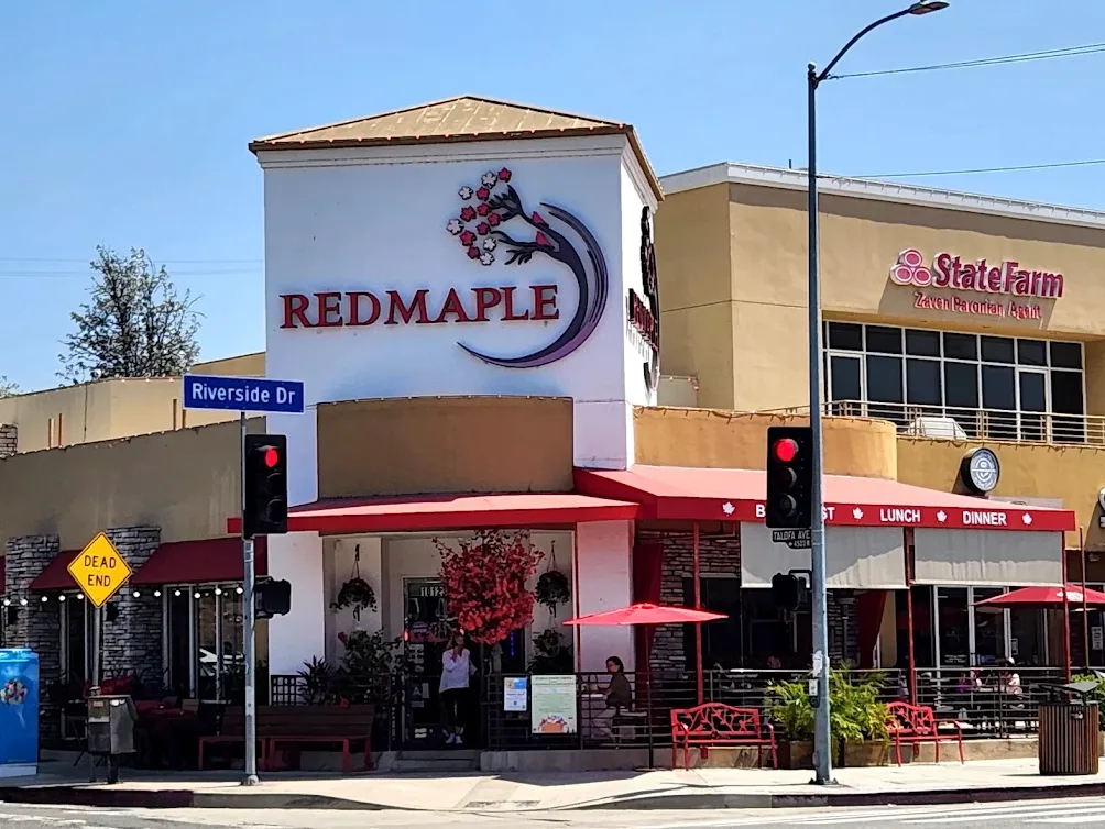 Red Maple Cafe exterior with its red awning and maple tree on Riverside Drive